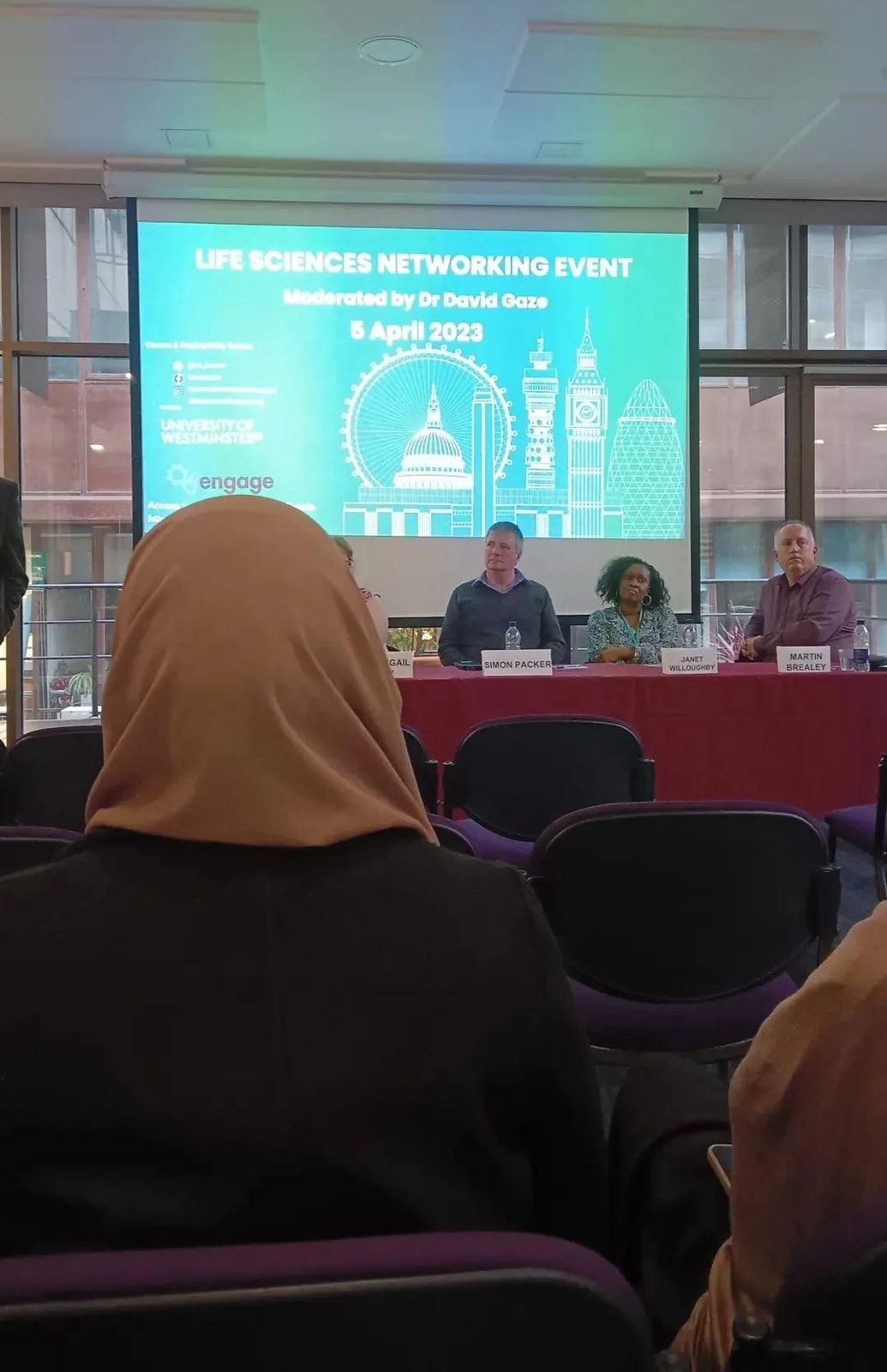 Audience facing a four-person panel in front of a screen reading Life Sciences Networking Event, 5 April 2023